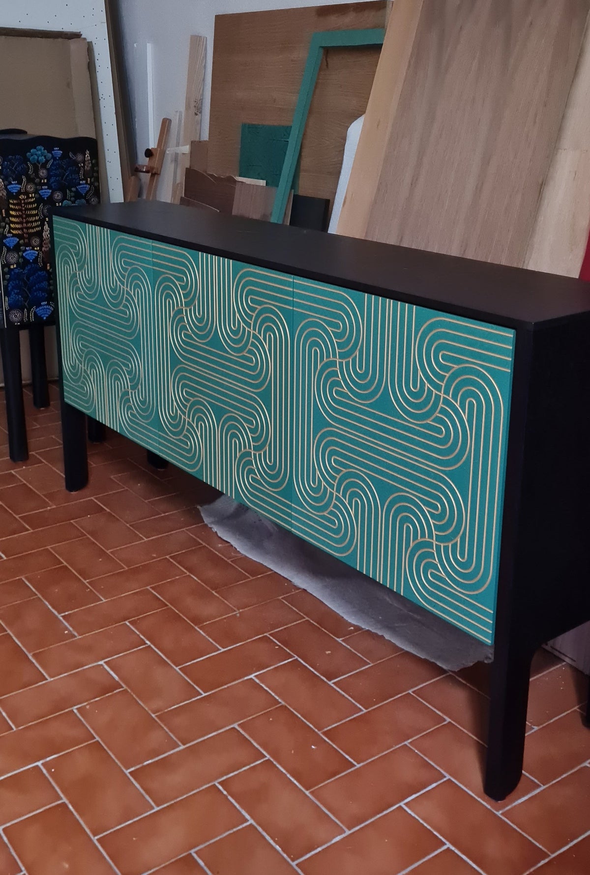 Emerald Sideboard with a grooved patterned surface painted in gold