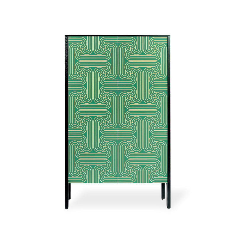 A modern two-door cabinet featuring a green and gold geometric maze-like pattern on the doors, with a black frame and slim black legs, shown against a plain white background.