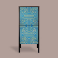 A modern two-door cabinet featuring a vibrant blue and teal geometric pattern on the doors, framed in black with slim black legs, set against a solid taupe background.