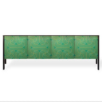 A modern sideboard or credenza with a green and teal geometric wavy pattern on the doors, supported by slim black legs, shown against a plain white background.