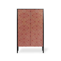 A tall cabinet with two doors featuring a red and gold geometric maze-like pattern, supported by slim black legs, shown against a plain white background.