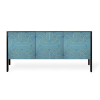 A modern sideboard or credenza with a blue and gold geometric patterned front, supported by slim black legs, shown against a plain white background.