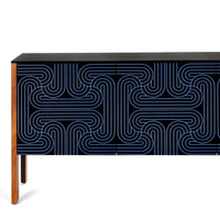 A modern sideboard or credenza with a black top and front featuring a blue and black geometric maze-like line pattern, supported by a light wood frame and single leg, shown against a plain white background.